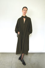 Back view of the carob Lyocell Kamperett Lore Trench Coat with raglan sleeve construction.