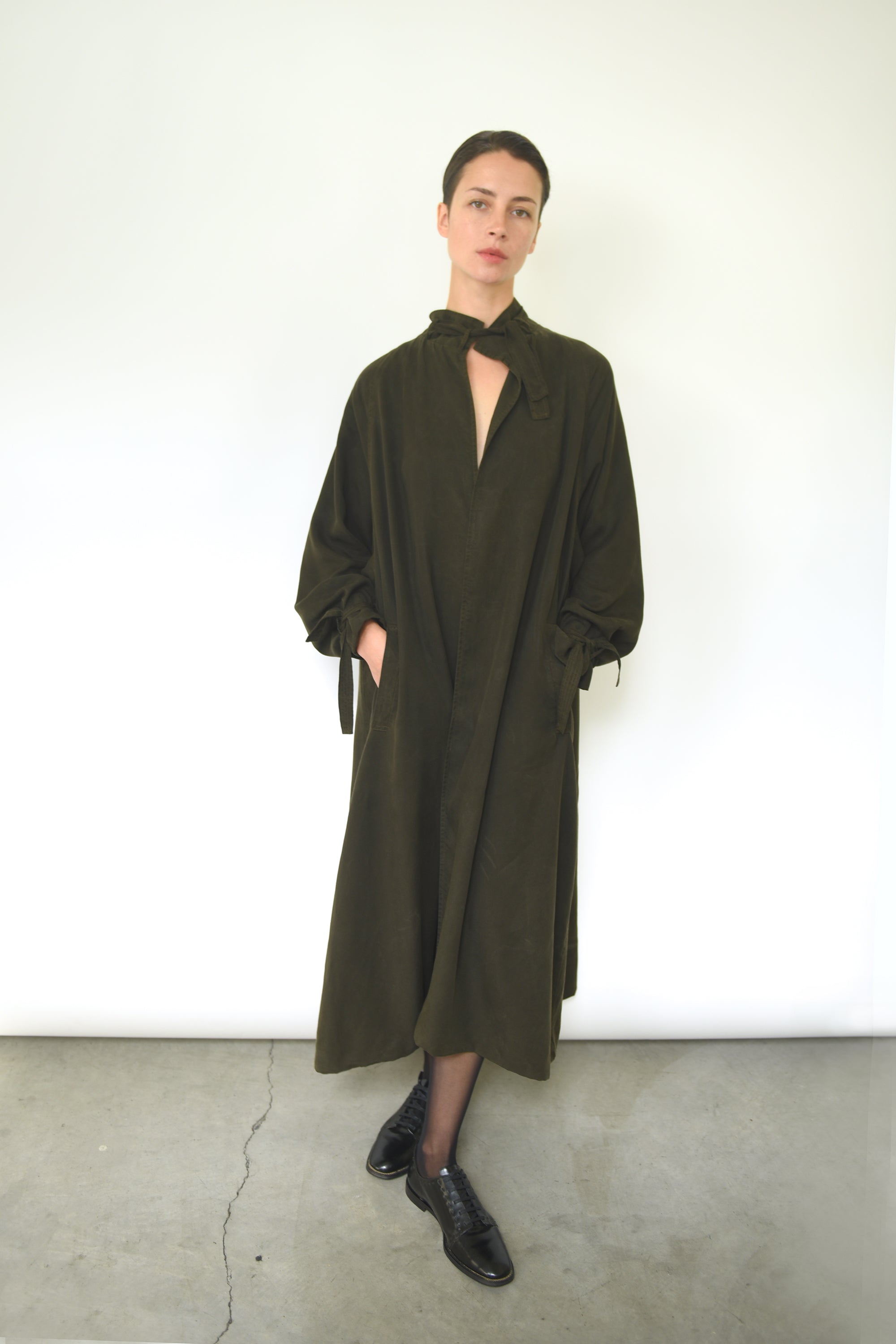 Back view of the carob Lyocell Kamperett Lore Trench Coat with raglan sleeve construction.