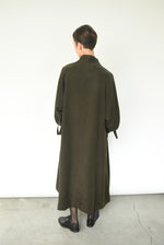 Close-up of the self tie at the cuff on the carob Lyocell Kamperett Lore Trench Coat.