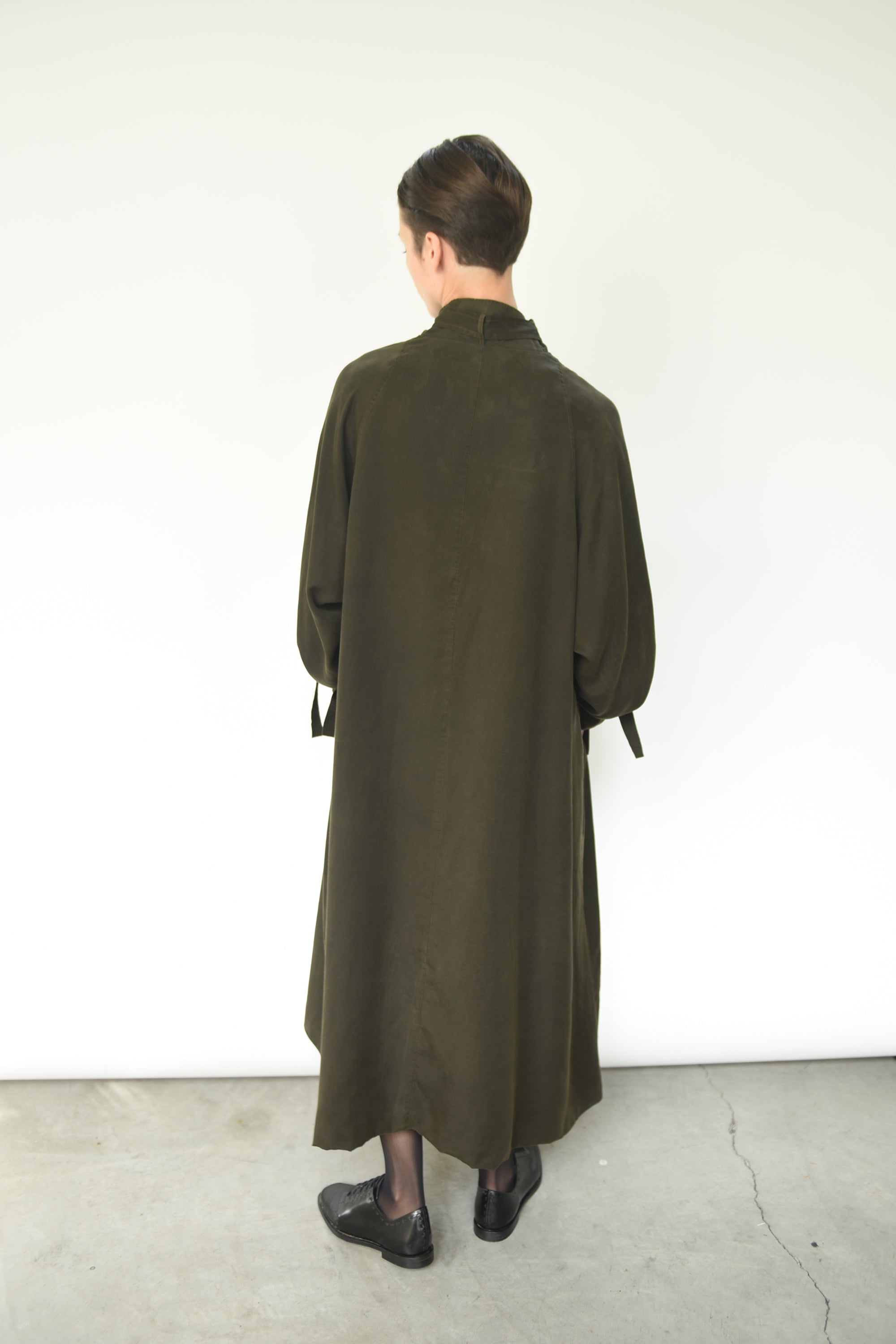 Close-up of the self tie at the cuff on the carob Lyocell Kamperett Lore Trench Coat.