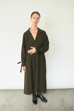 Styled view of the carob Lyocell Kamperett Lore Trench Coat with welt pockets at the front.