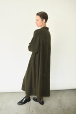 Side view of the carob Lyocell Kamperett Lore Trench Coat with raglan sleeves and self ties.