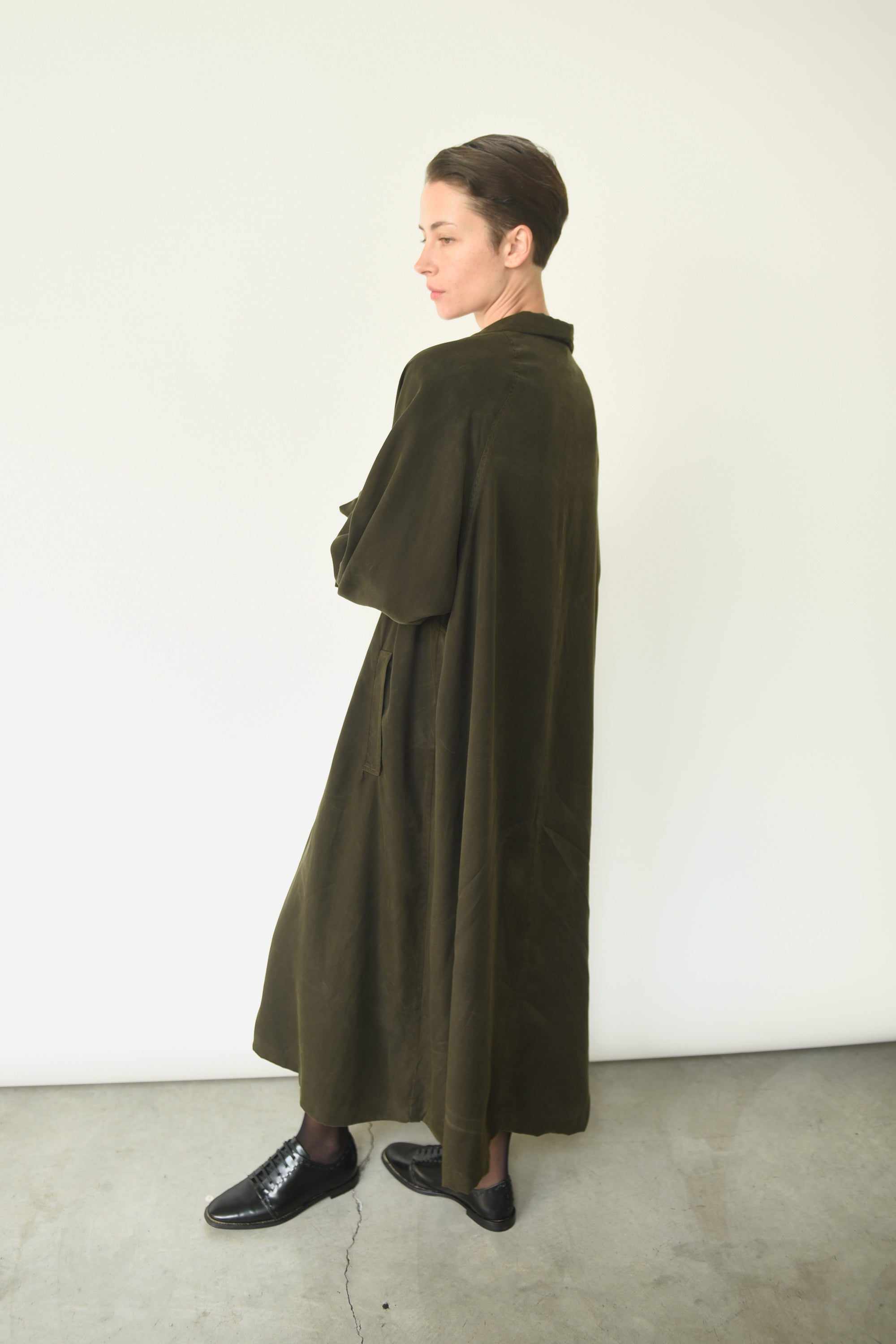 Side view of the carob Lyocell Kamperett Lore Trench Coat with raglan sleeves and self ties.