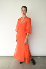 Editorial image of the vermilion silk organza Kamperett Loretta Midi Dress.