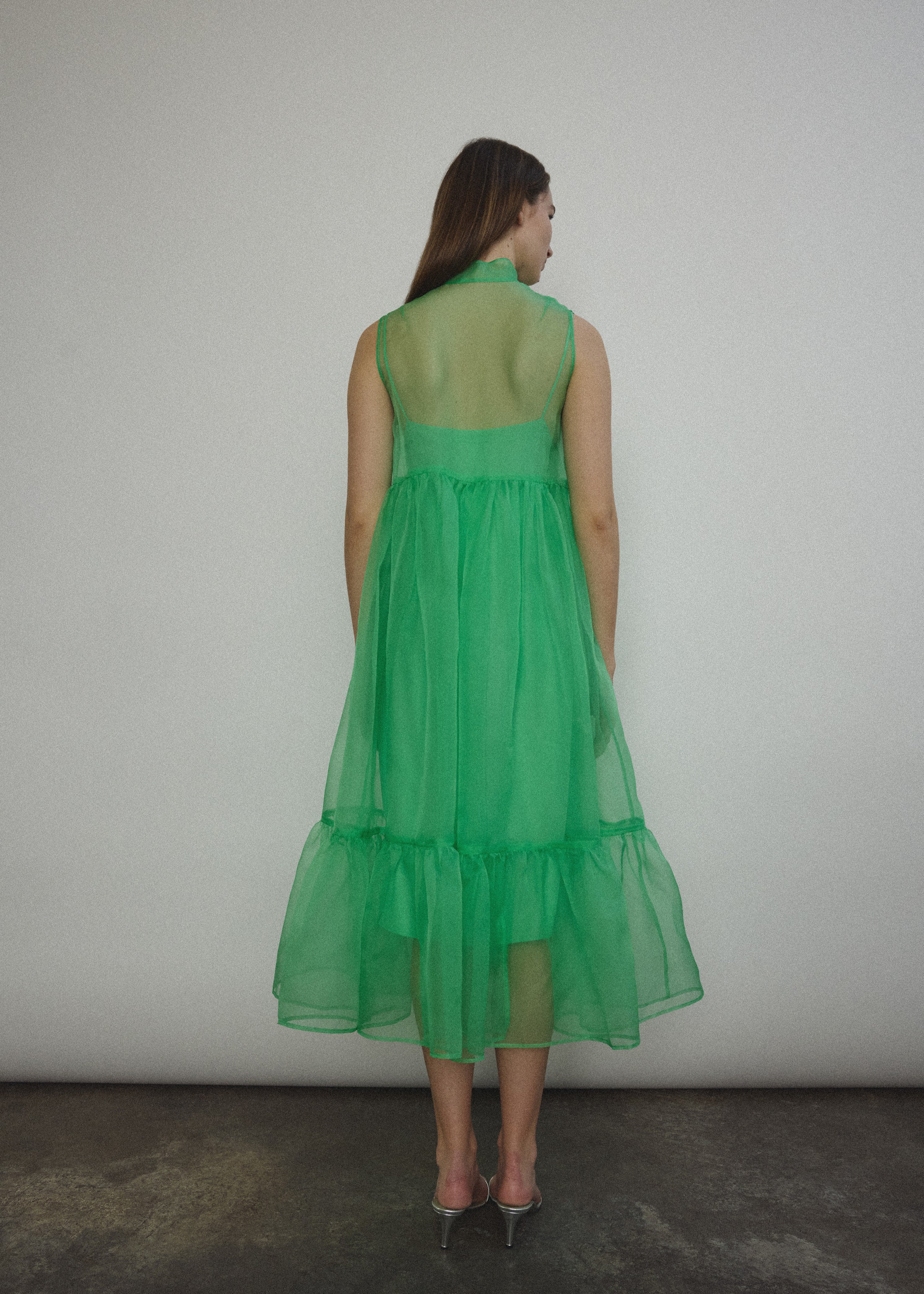 Back view of the celadon silk organza Kamperett Mae Dress with empire waist seaming.