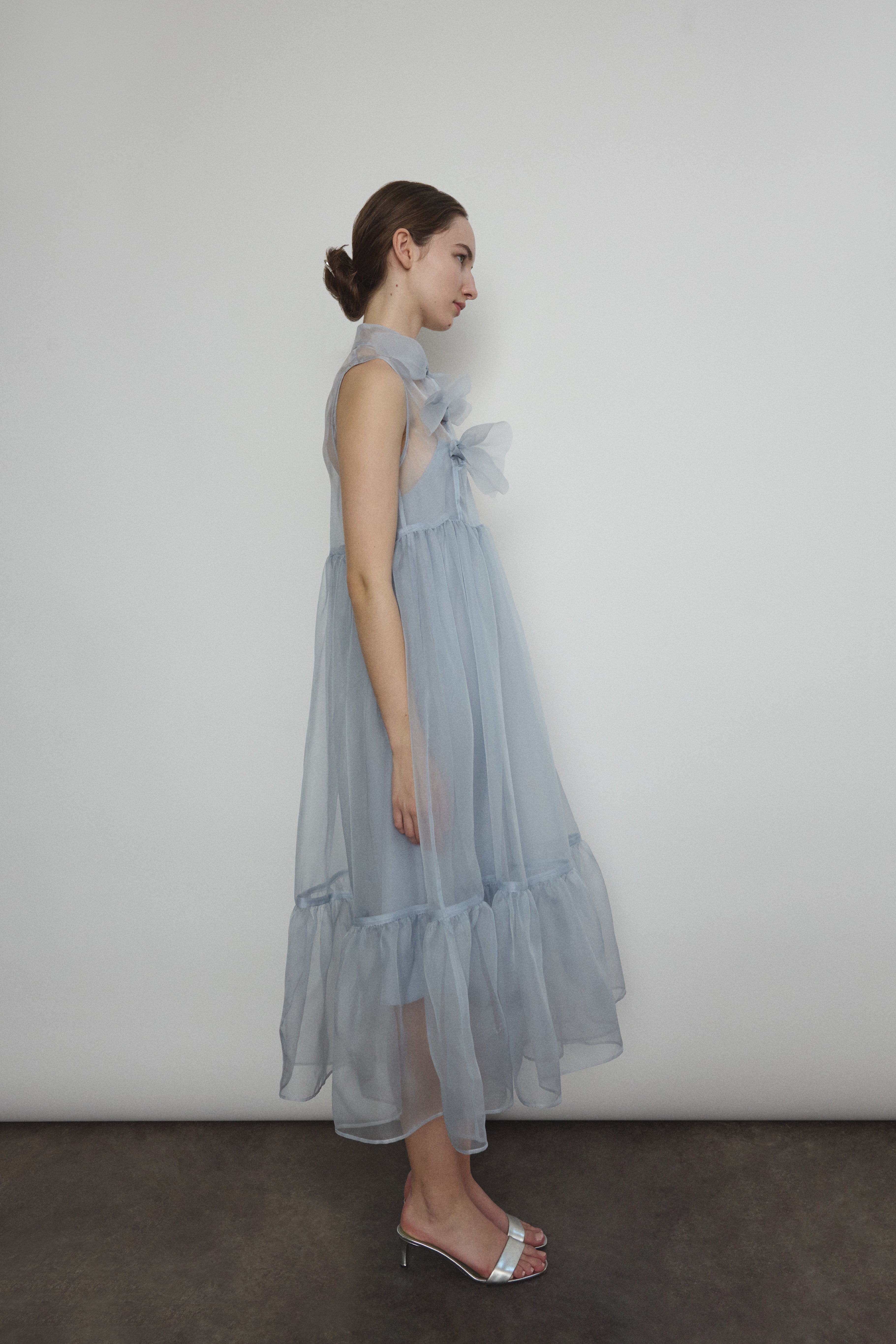 Motion shot of the powder blue silk organza Kamperett Mae Dress, capturing the fluid ruffle hem.