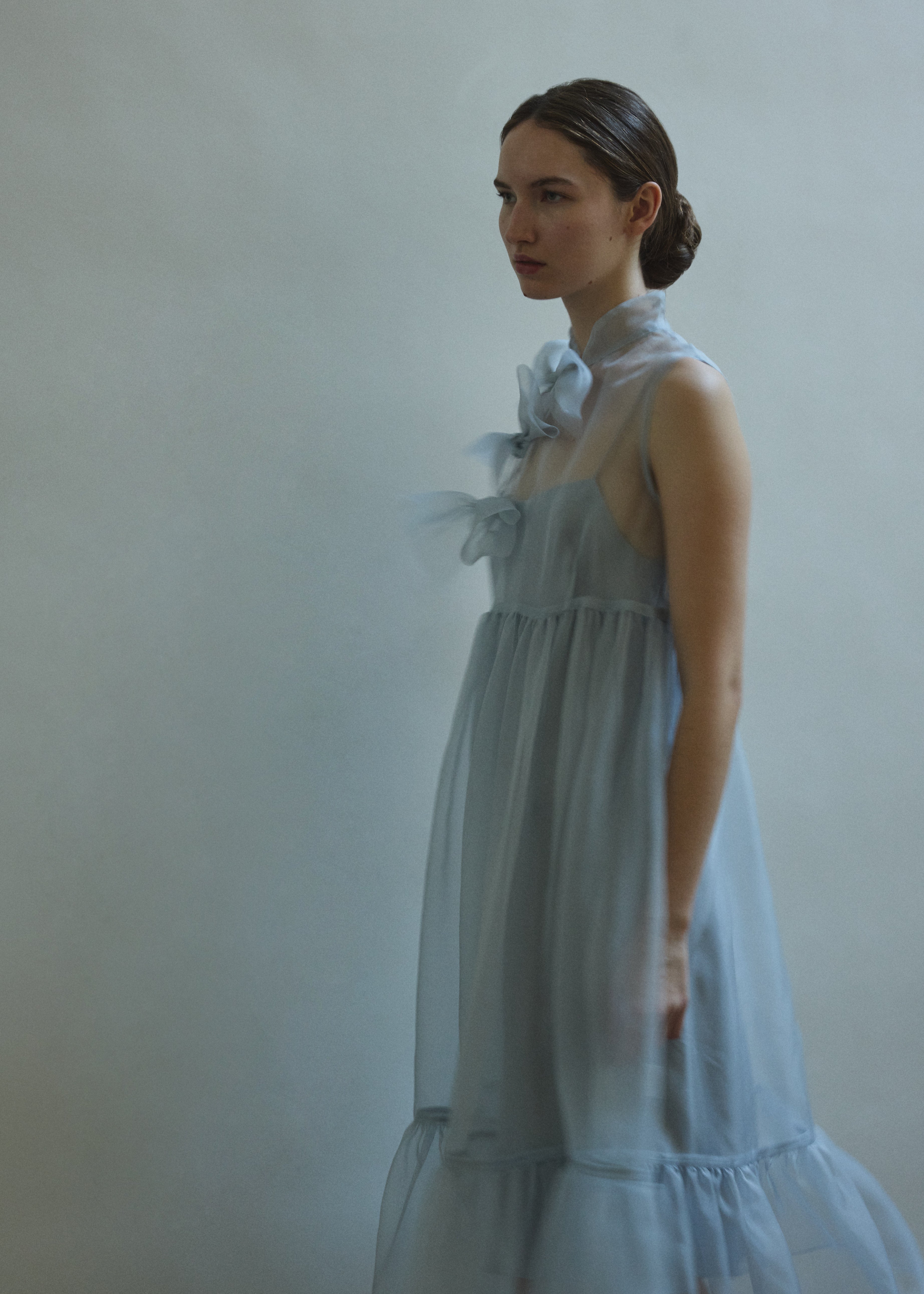 Side view of the powder blue silk organza Kamperett Mae Dress showing the full skirt and gathered hem ruffle.