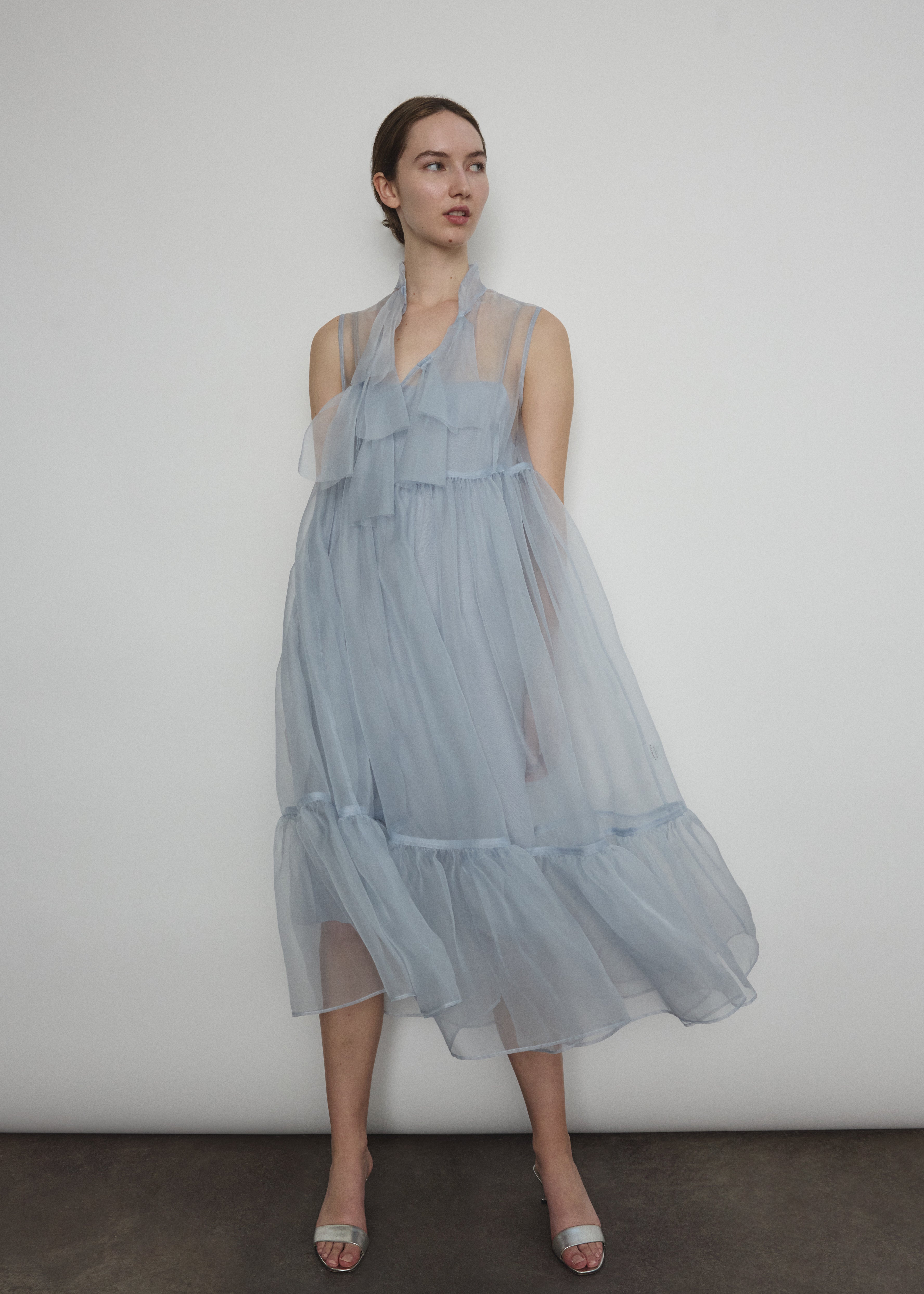 Detail of the qipao-inspired tie front closure on the powder blue silk organza Kamperett Mae Dress.
