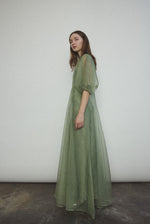 Back view of the jade silk organza Kamperett Meiere Gown with mock neck and back button closure.
