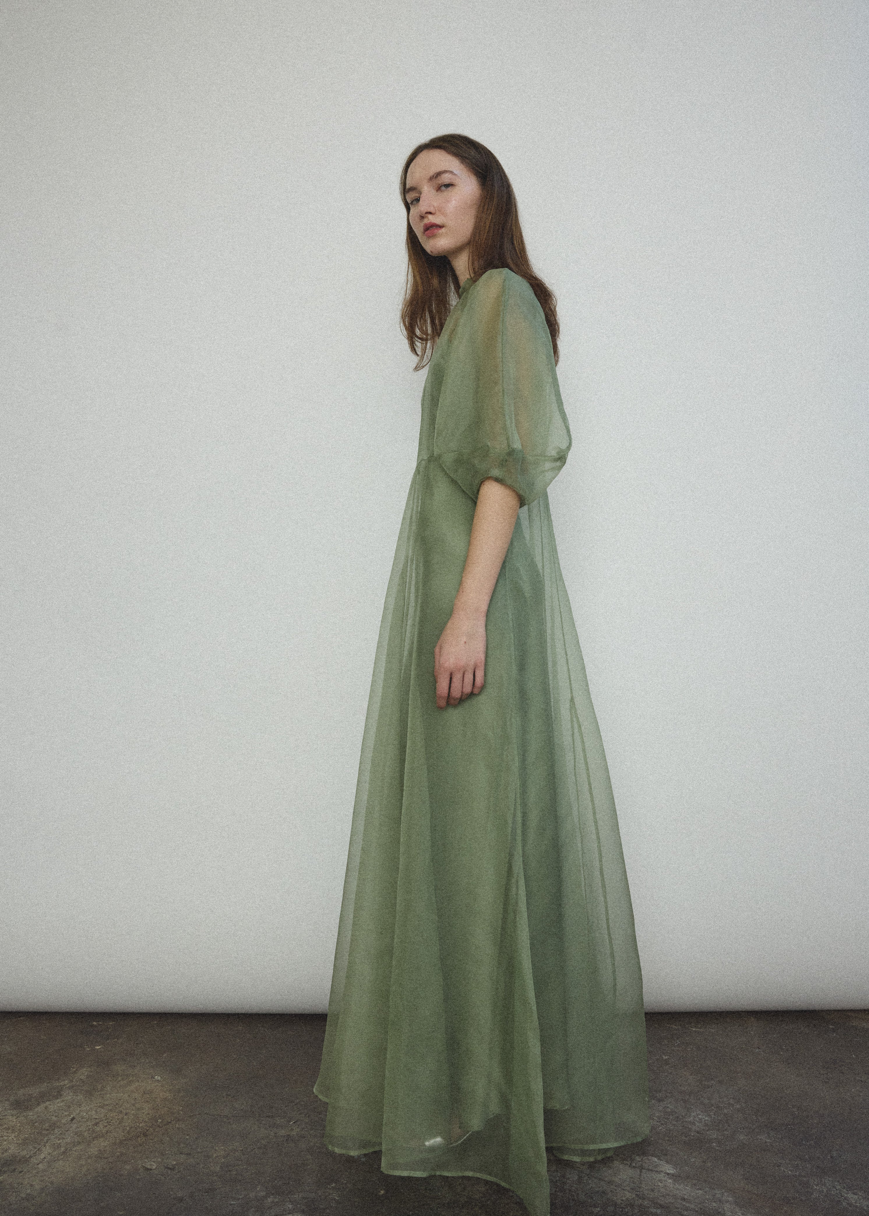 Back view of the jade silk organza Kamperett Meiere Gown with mock neck and back button closure.