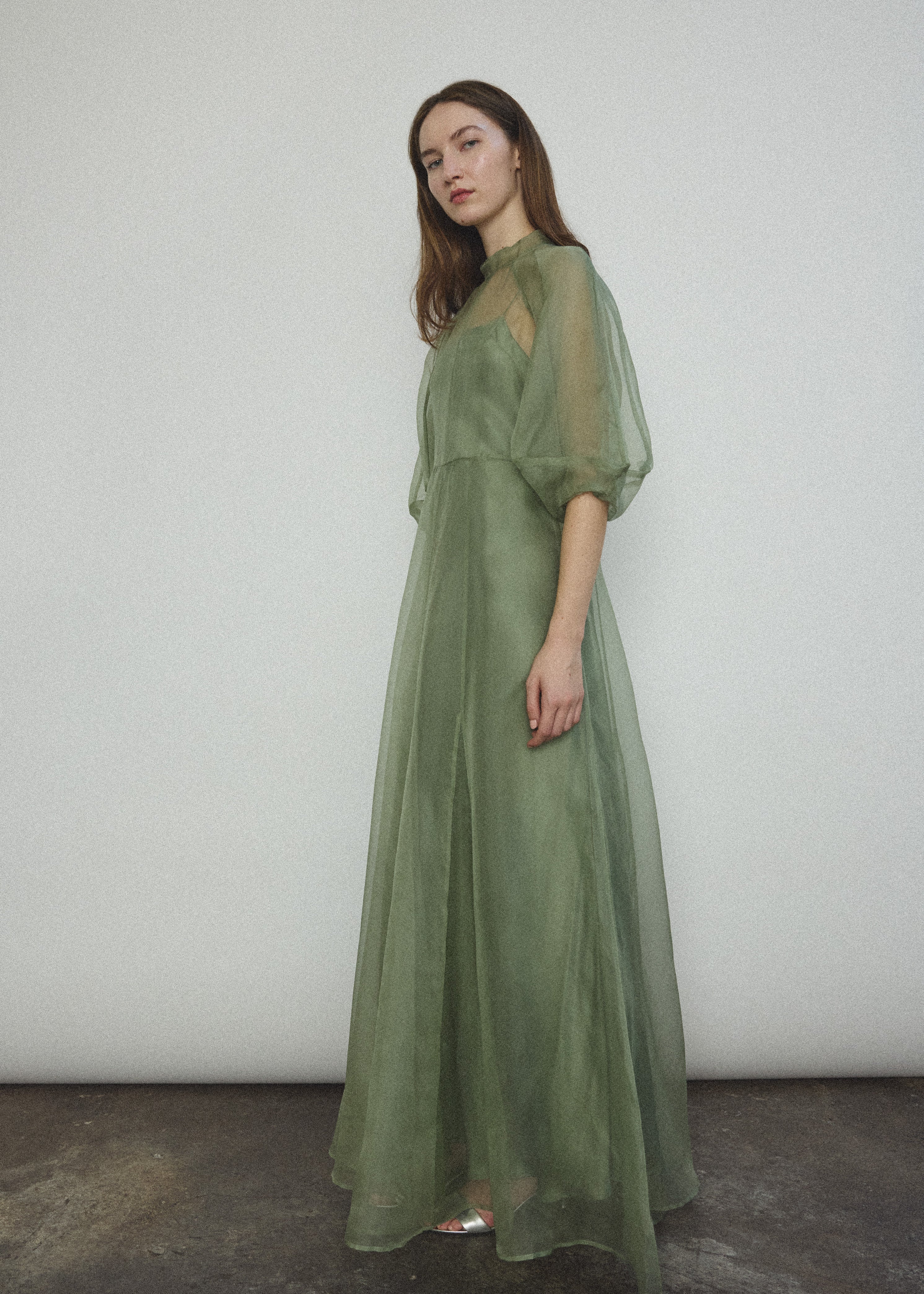 Side view of the jade silk organza Kamperett Meiere Gown showing the multi-godet skirt.