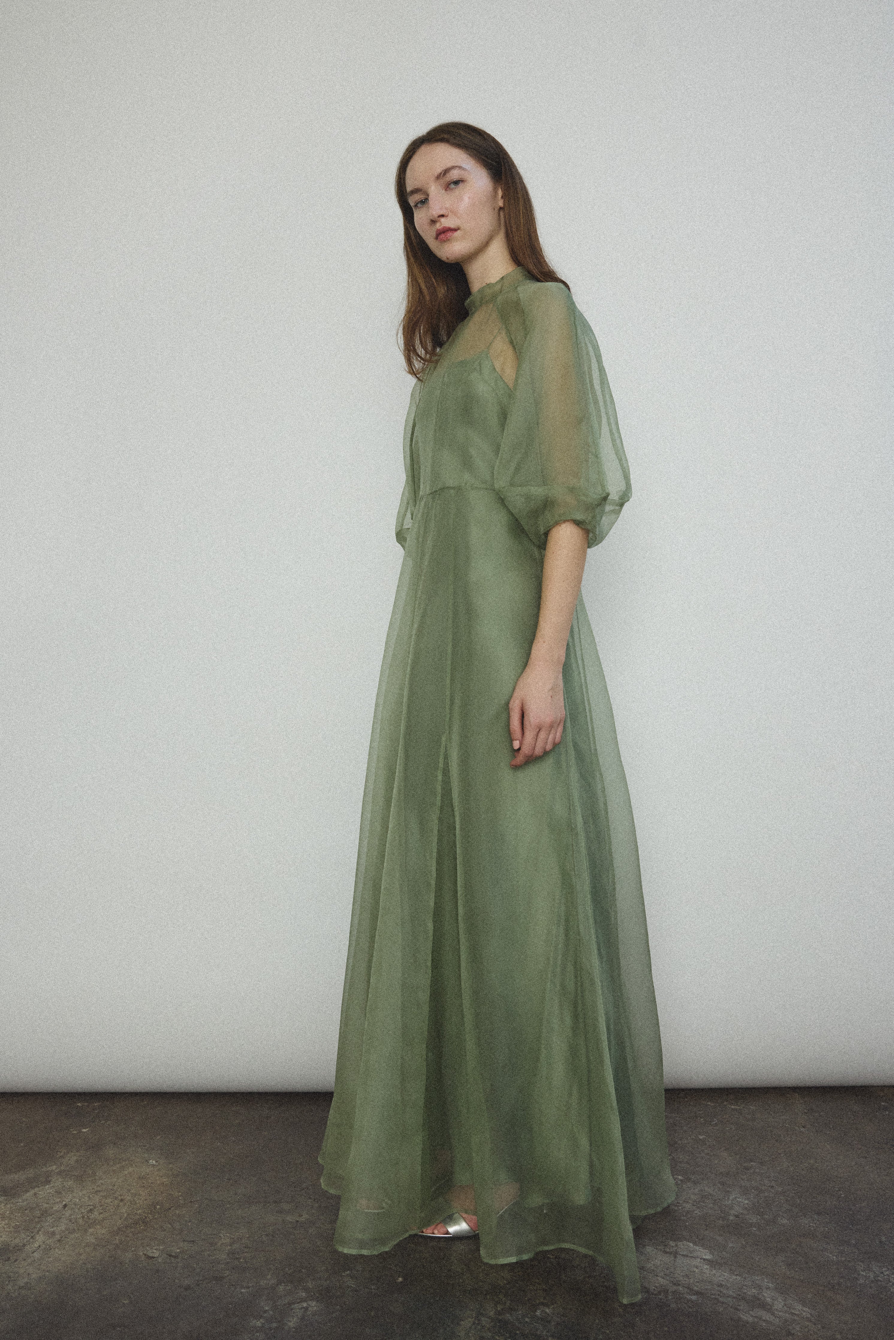 Side view of the jade silk organza Kamperett Meiere Gown showing the multi-godet skirt.