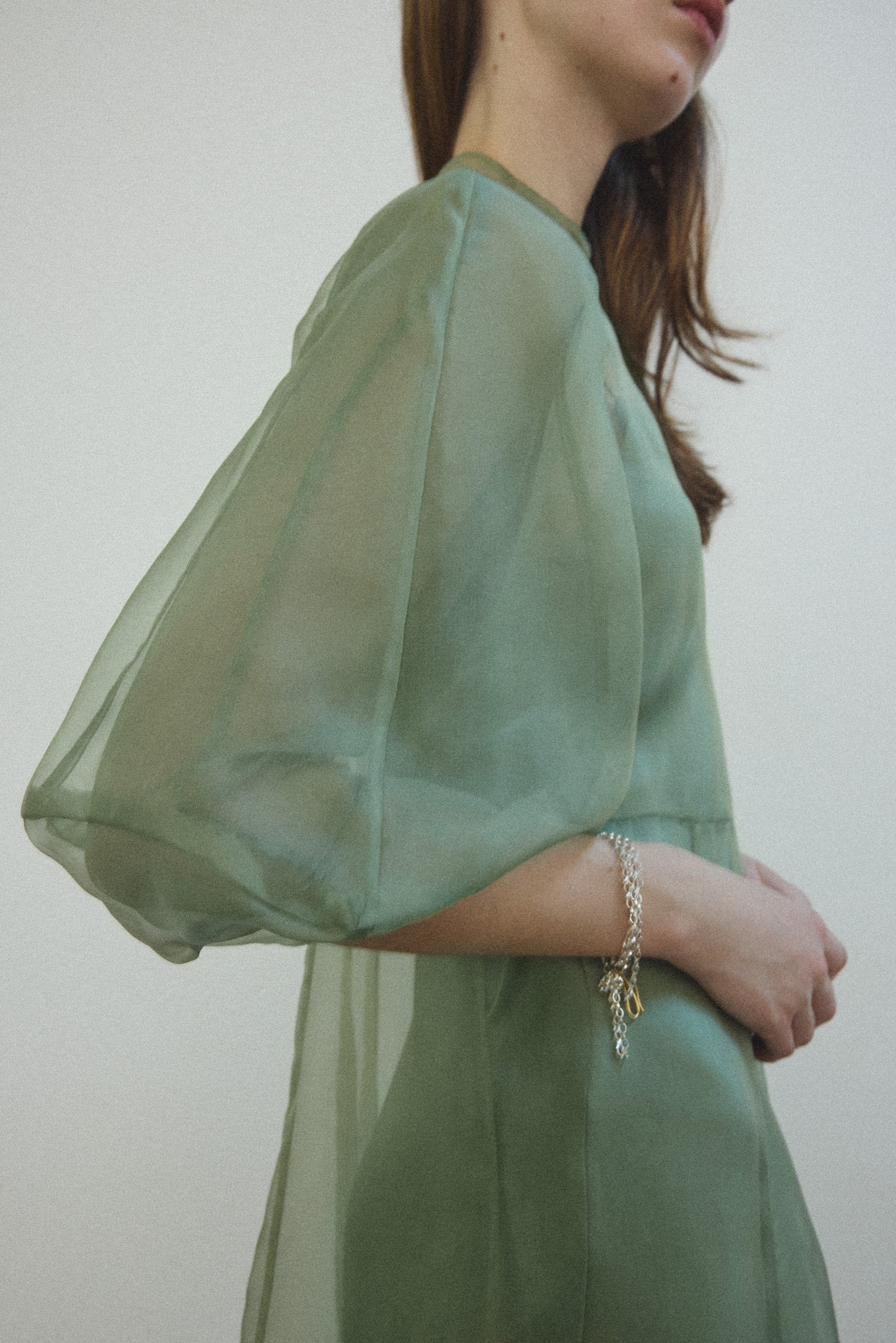 Detail of the architectural cut-glass-inspired sleeves on the jade silk organza Kamperett Meiere Gown.