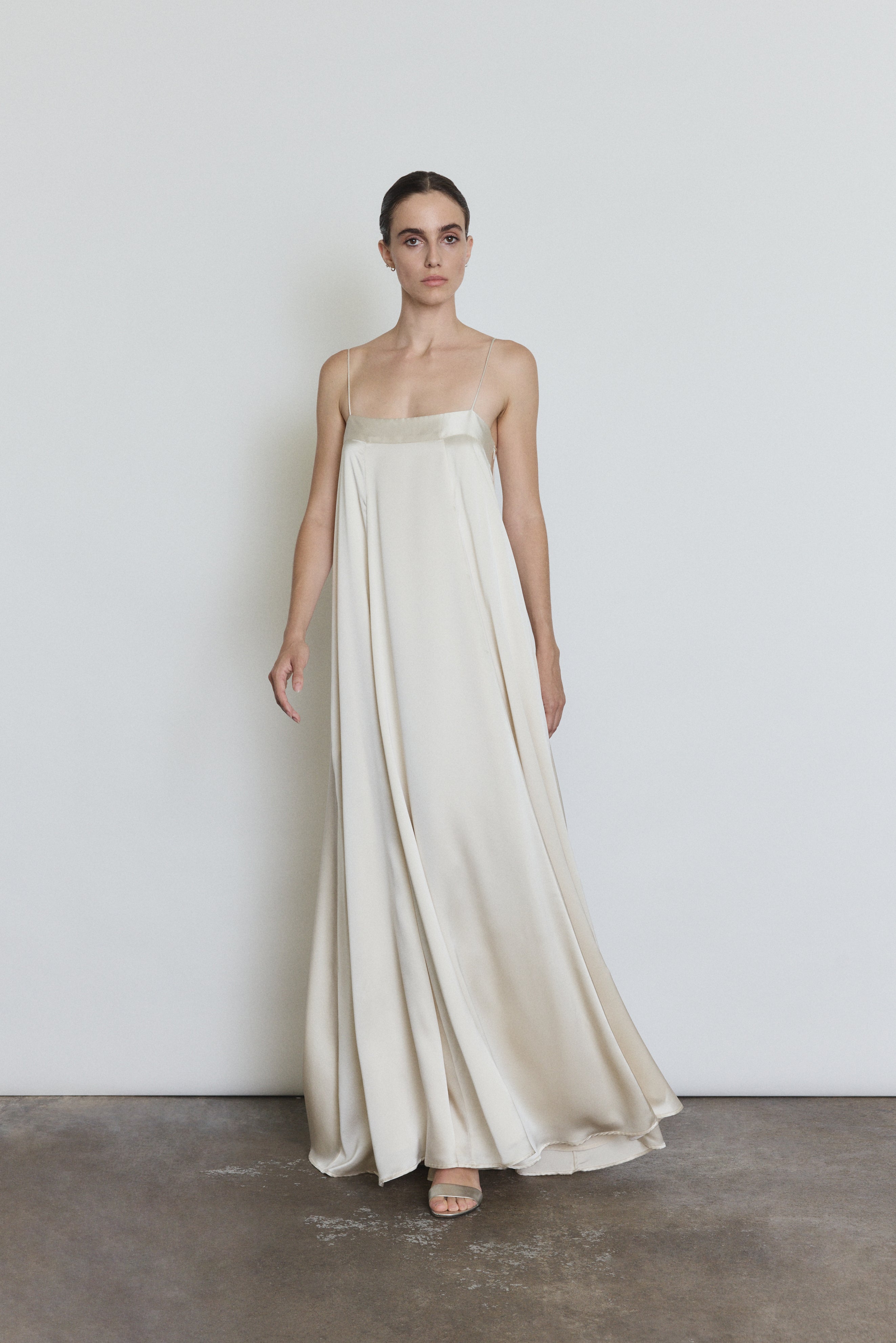 Detail of the ivory silk Kamperett Metronome Gown showing the fabric and in-seam pockets.