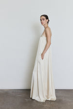 Side view of the ivory silk Kamperett Metronome Gown showing the column silhouette.