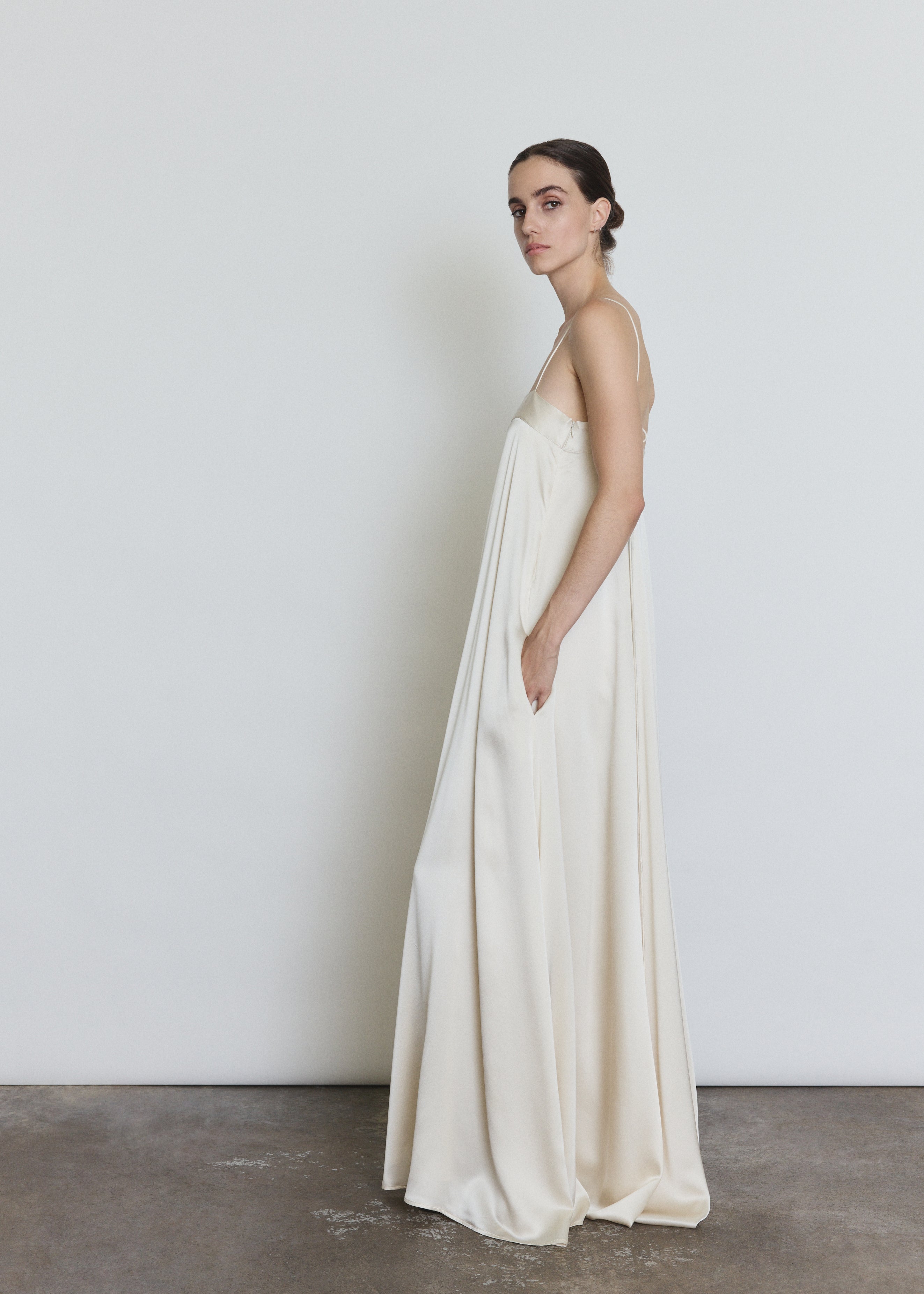 Side view of the ivory silk Kamperett Metronome Gown showing the column silhouette.