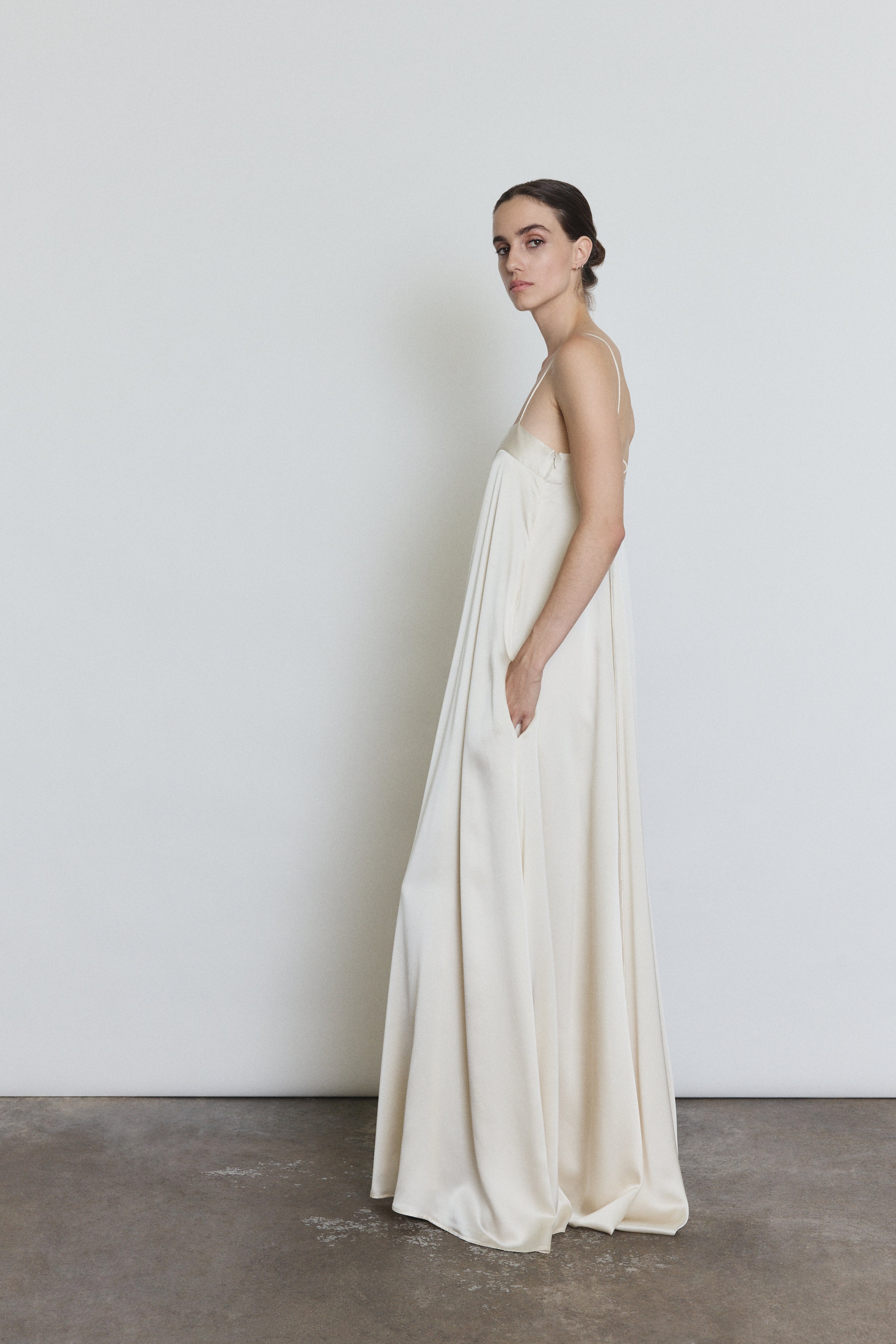 Side view of the ivory silk Kamperett Metronome Gown showing the column silhouette.