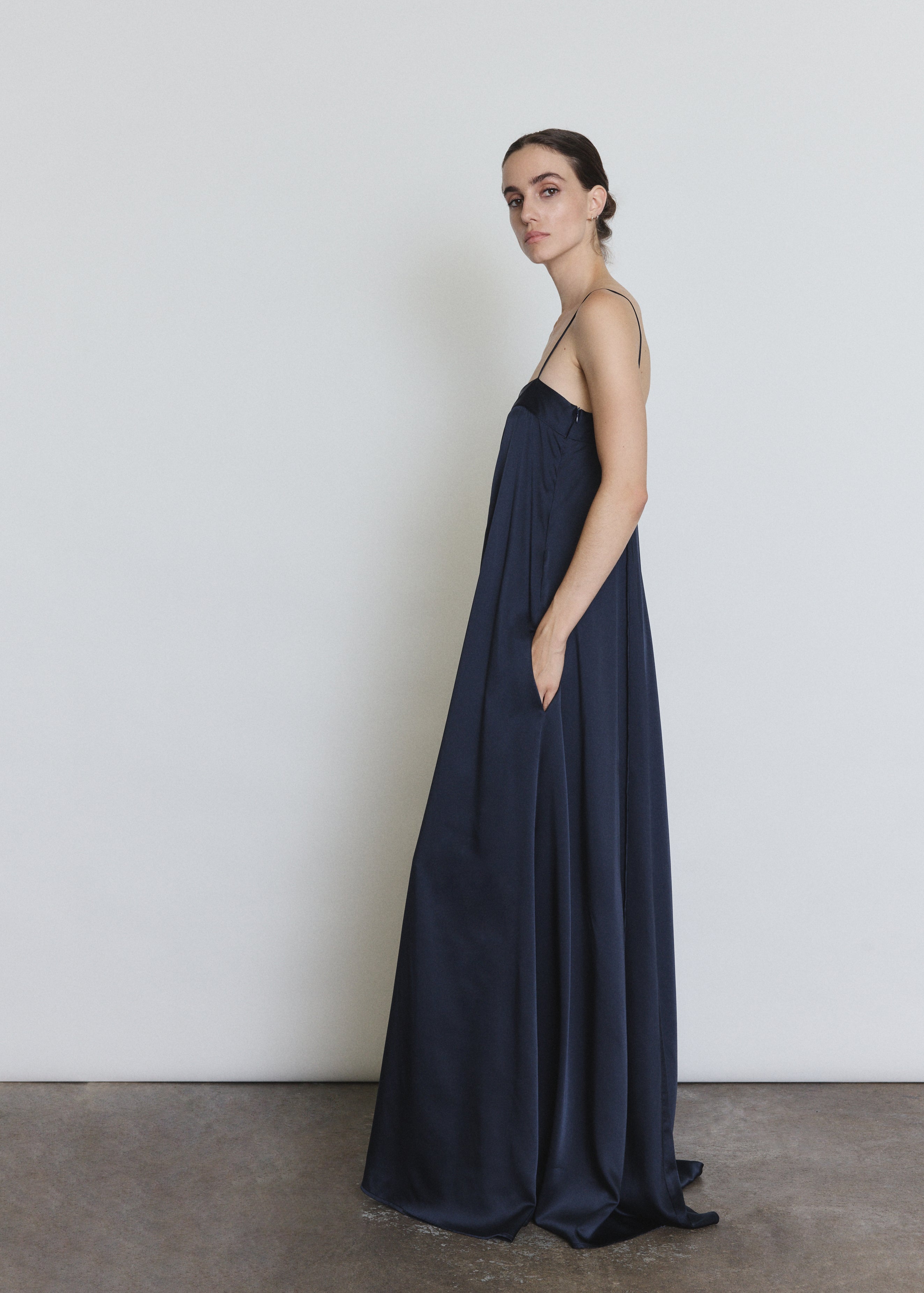 Side view of the midnight silk Kamperett Metronome Gown showing the column silhouette.
