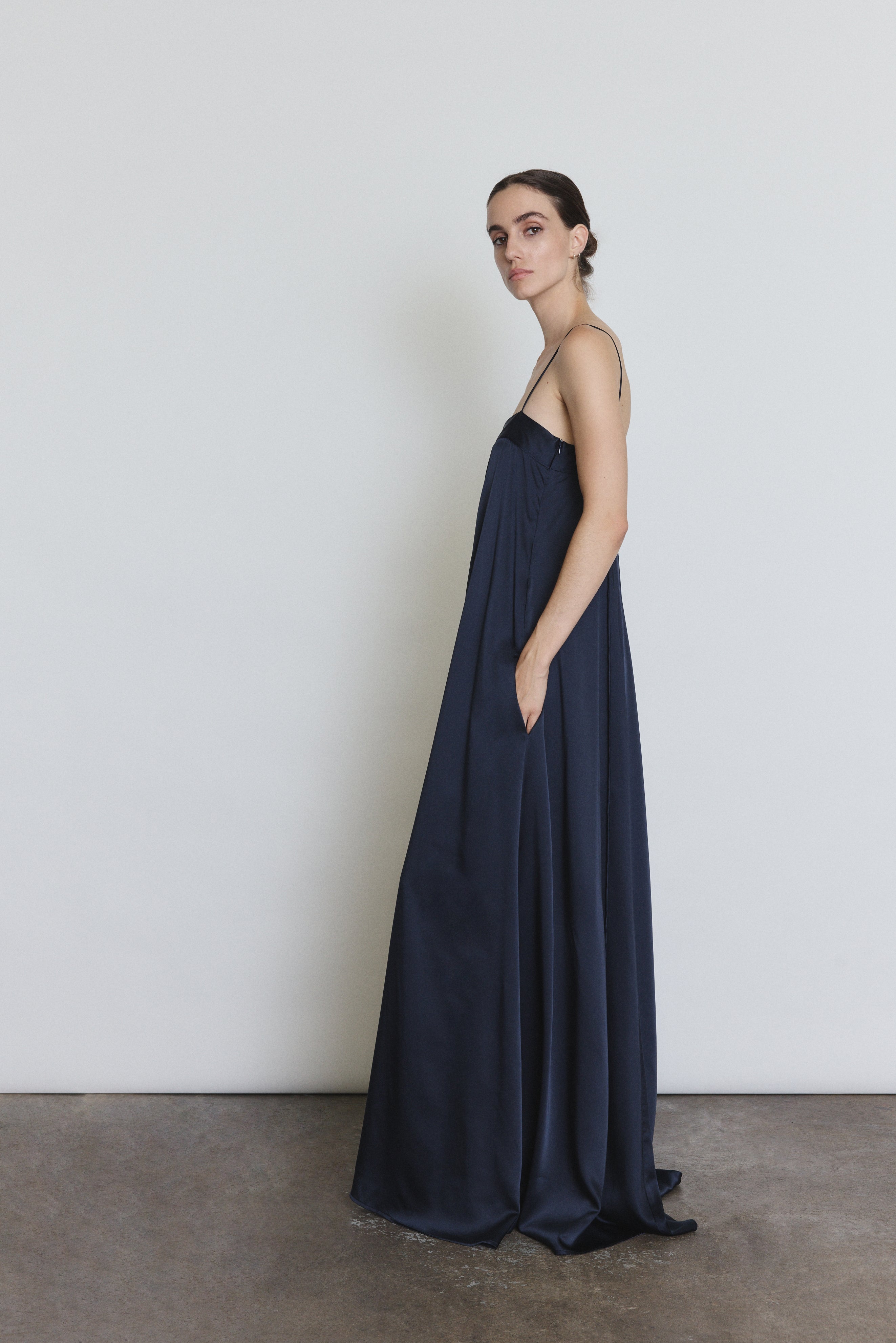 Side view of the midnight silk Kamperett Metronome Gown showing the column silhouette.