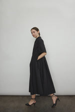 Angled view of the black Japanese cotton lawn Kamperett Miller Dress with hidden placket button front.