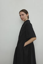Back view of the black Japanese cotton lawn Kamperett Miller Dress showing the oversized shirt dress silhouette.