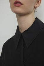 Detail of the straight collar and button front on the black Japanese cotton lawn Kamperett Miller Dress.