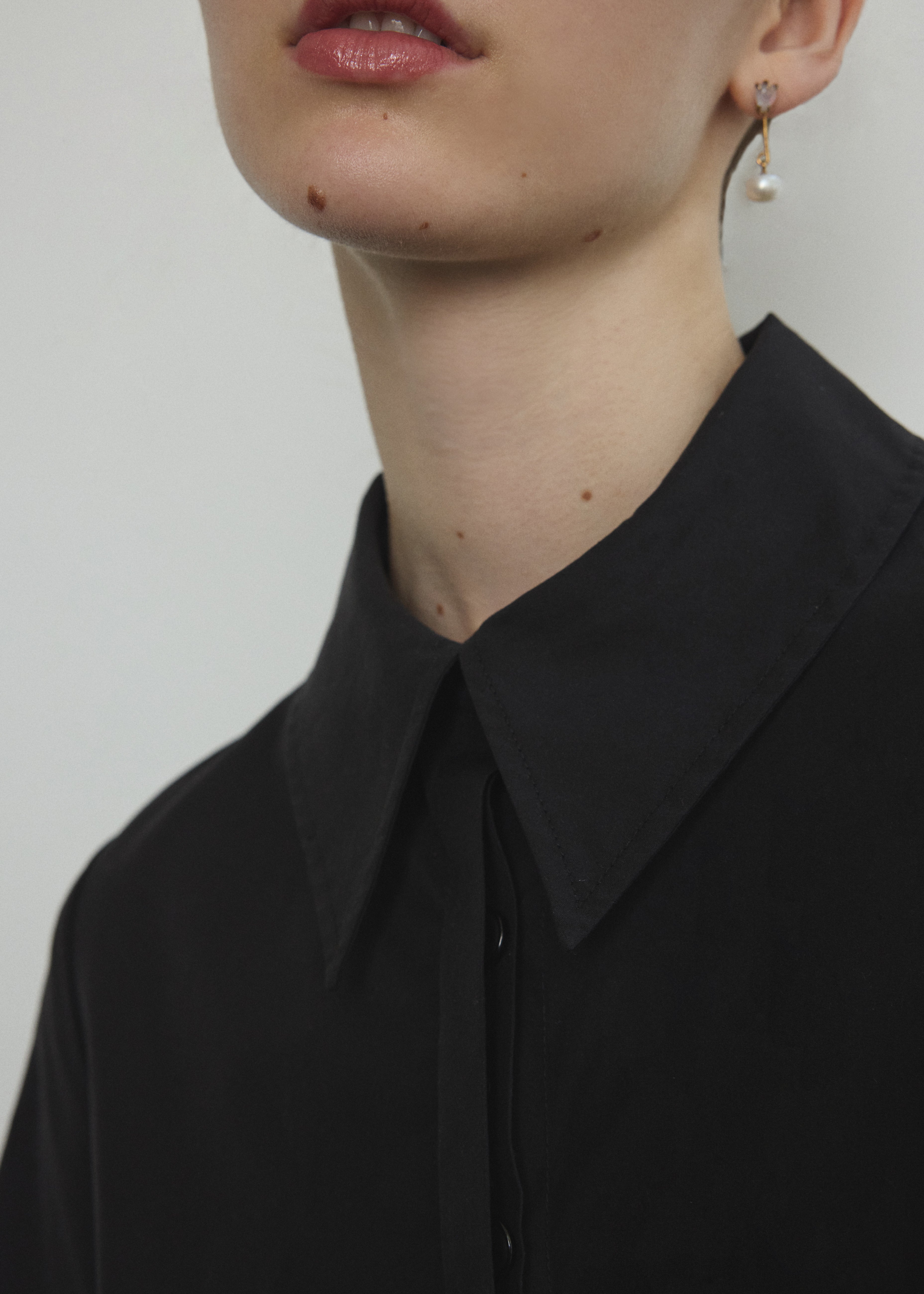 Detail of the straight collar and button front on the black Japanese cotton lawn Kamperett Miller Dress.