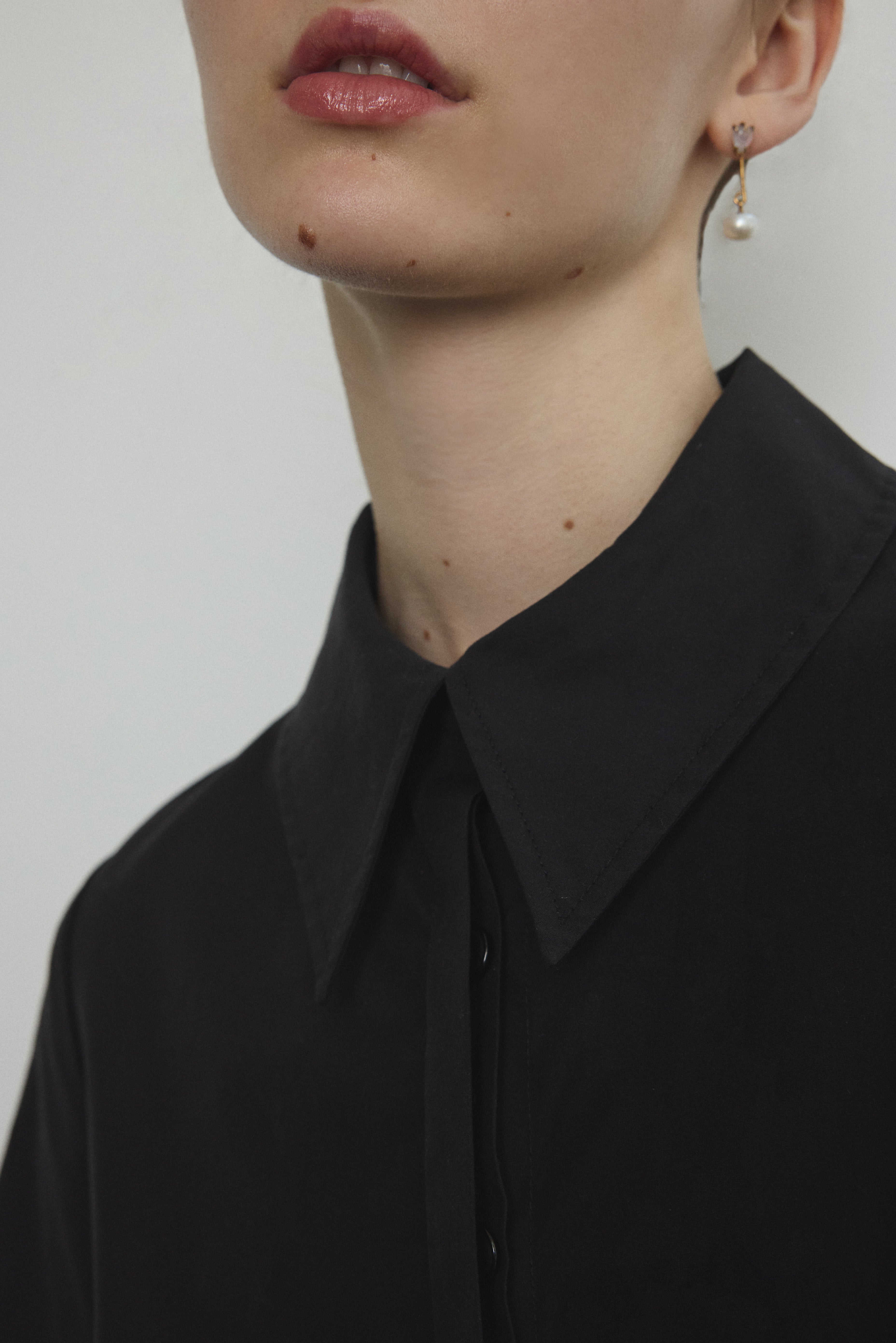 Detail of the straight collar and button front on the black Japanese cotton lawn Kamperett Miller Dress.