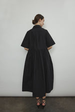 Side view of the black Japanese cotton lawn Kamperett Miller Dress with gathered waist and short sleeves.