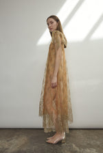 Left profile of Kamperett Moony Lace Gown in mink French lace, straight sheath silhouette with deconstructed cap sleeve and soft metallic detailing.