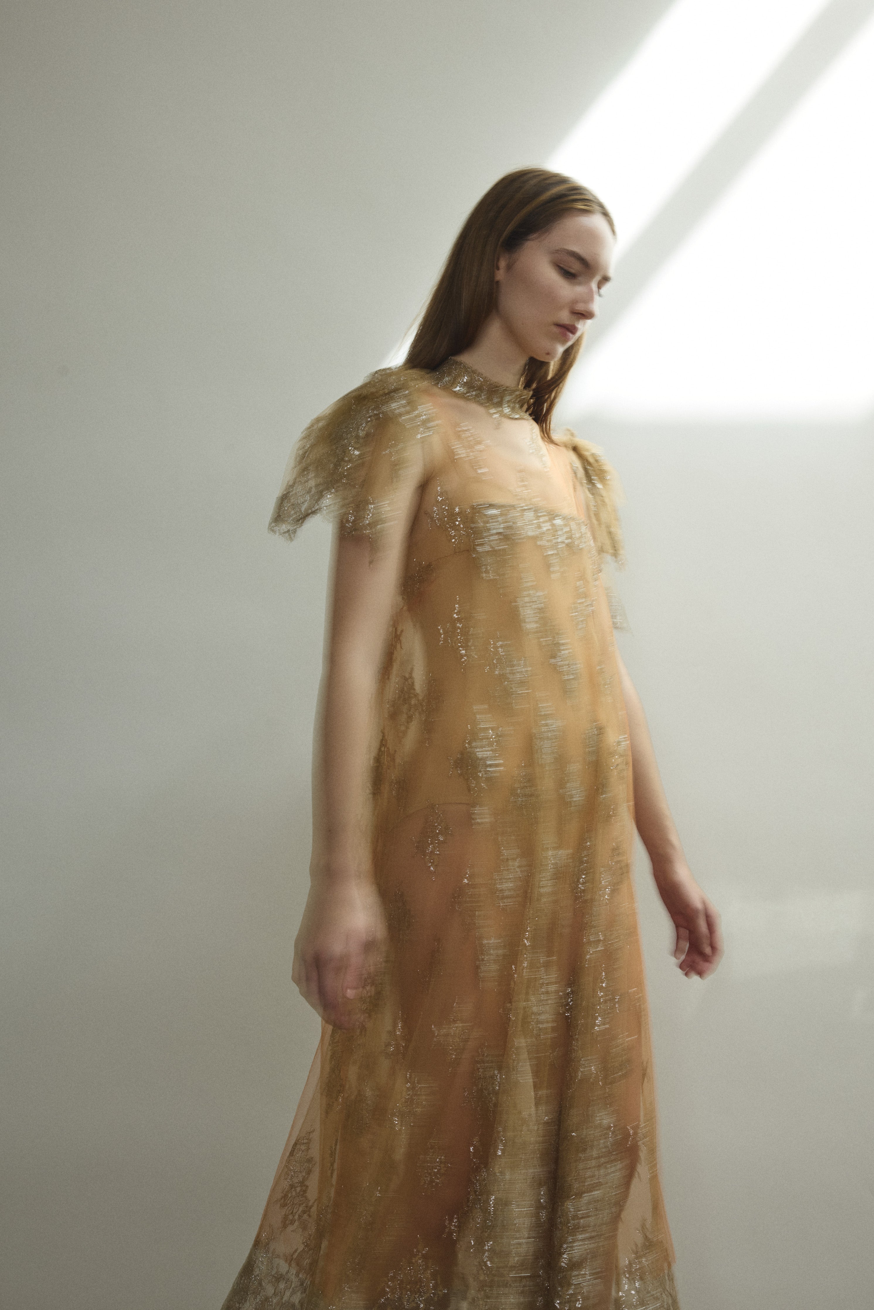 Right profile of Kamperett Moony Lace Gown — streamlined mock neck sheath in 100% French lace, soft neutral with metallic detail throughout. Made in California.