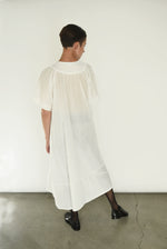 Back view of the white Kamperett Oma Dress with gathered yoke.