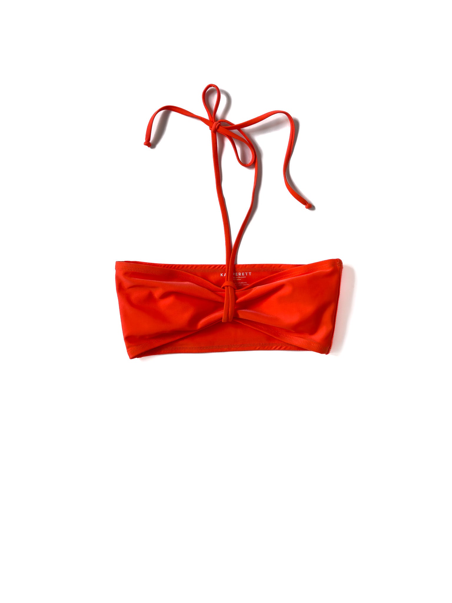 Flat image of the coral Italian regenerated nylon Kamperett Orra Bandeau Top.