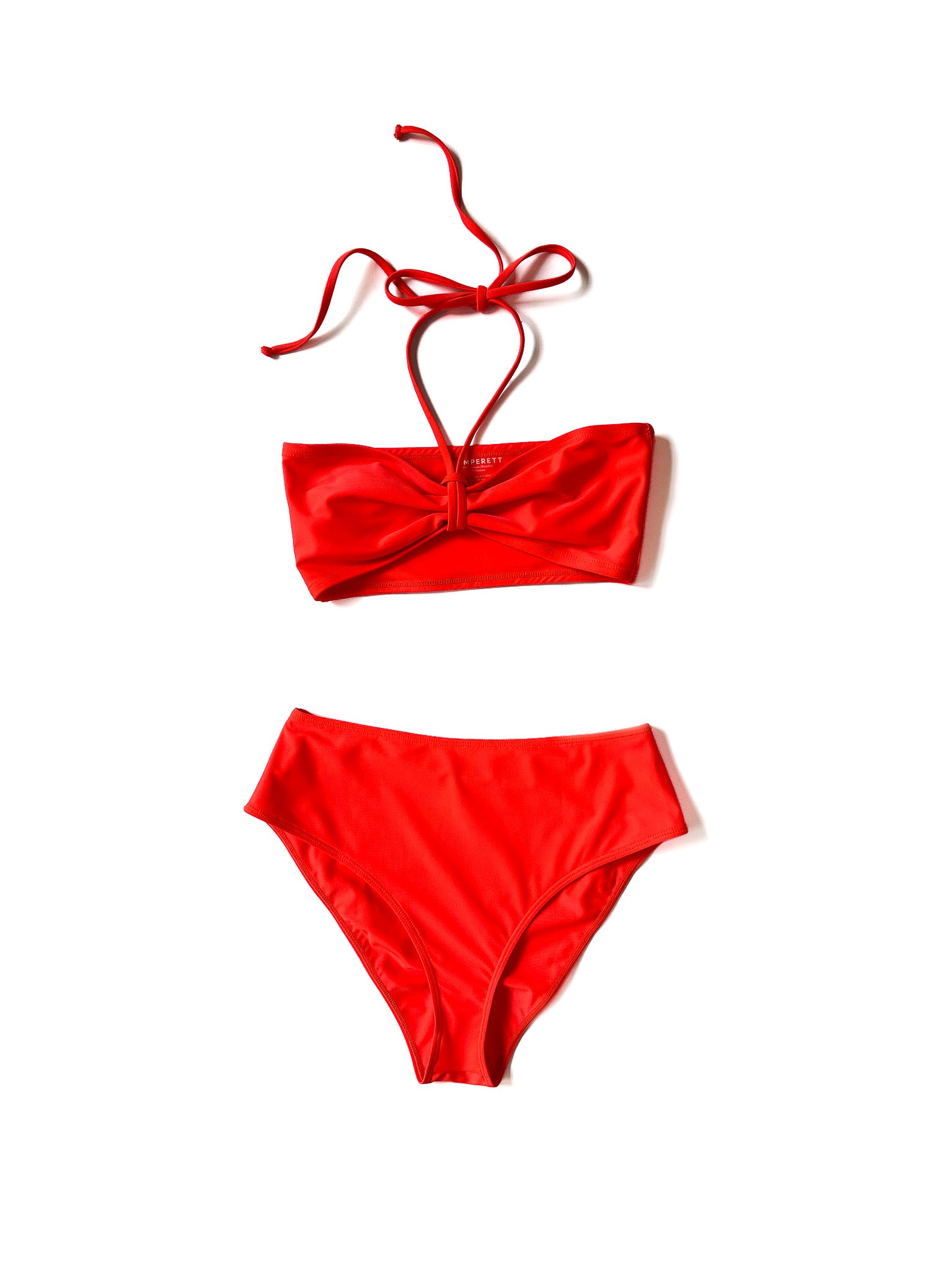 Flat image of the coral Italian regenerated nylon Kamperett Orra Bandeau Top in bandeau styling.