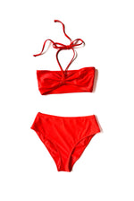 Flat image of the coral Italian regenerated nylon Kamperett Orra Bandeau Top in bandeau styling.