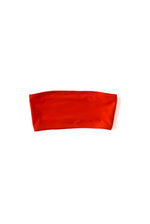 Alternate flat image of the coral Kamperett Orra Bandeau Top with halter cord attached.