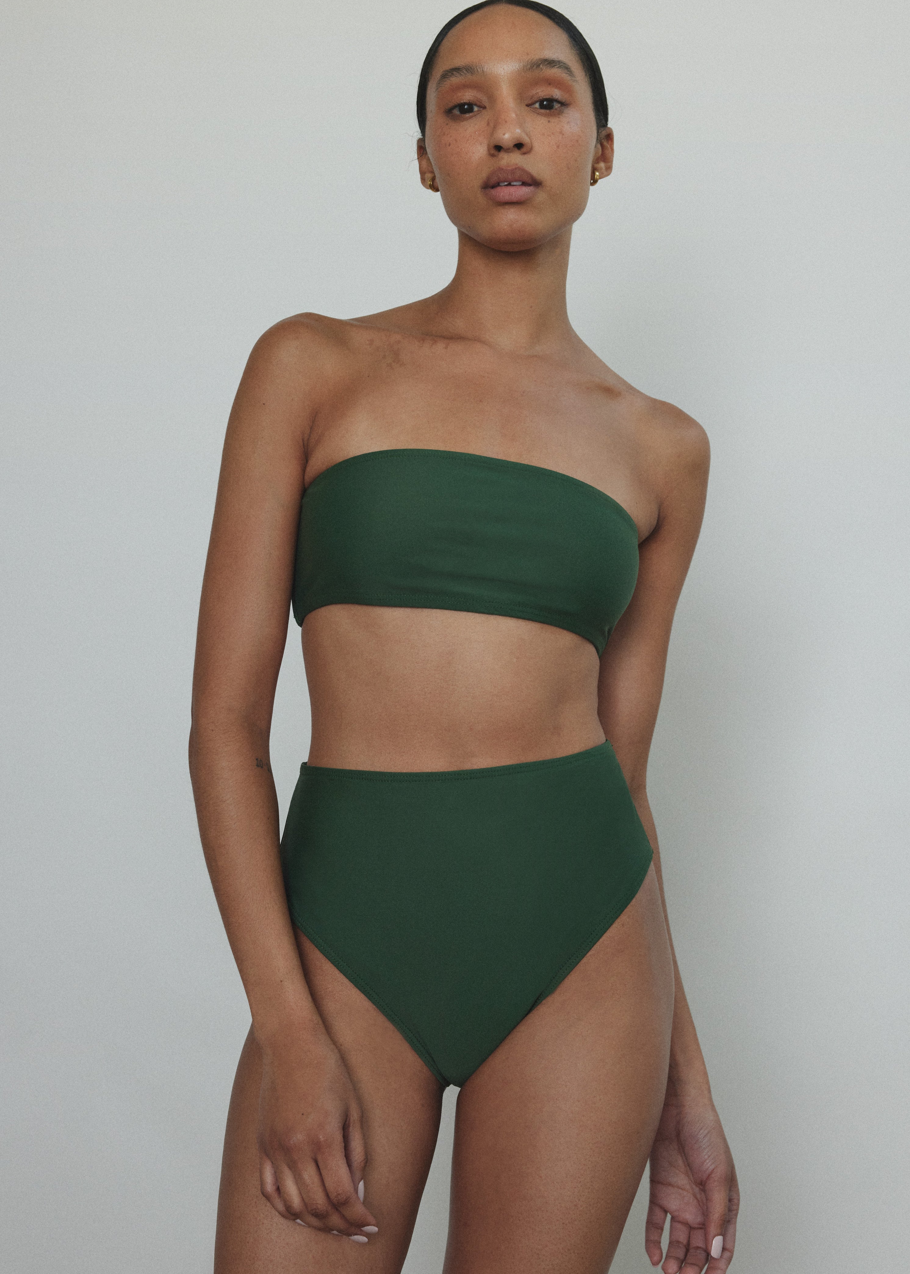 Editorial image of a model wearing the palm green Kamperett Orra High Waist Brief.