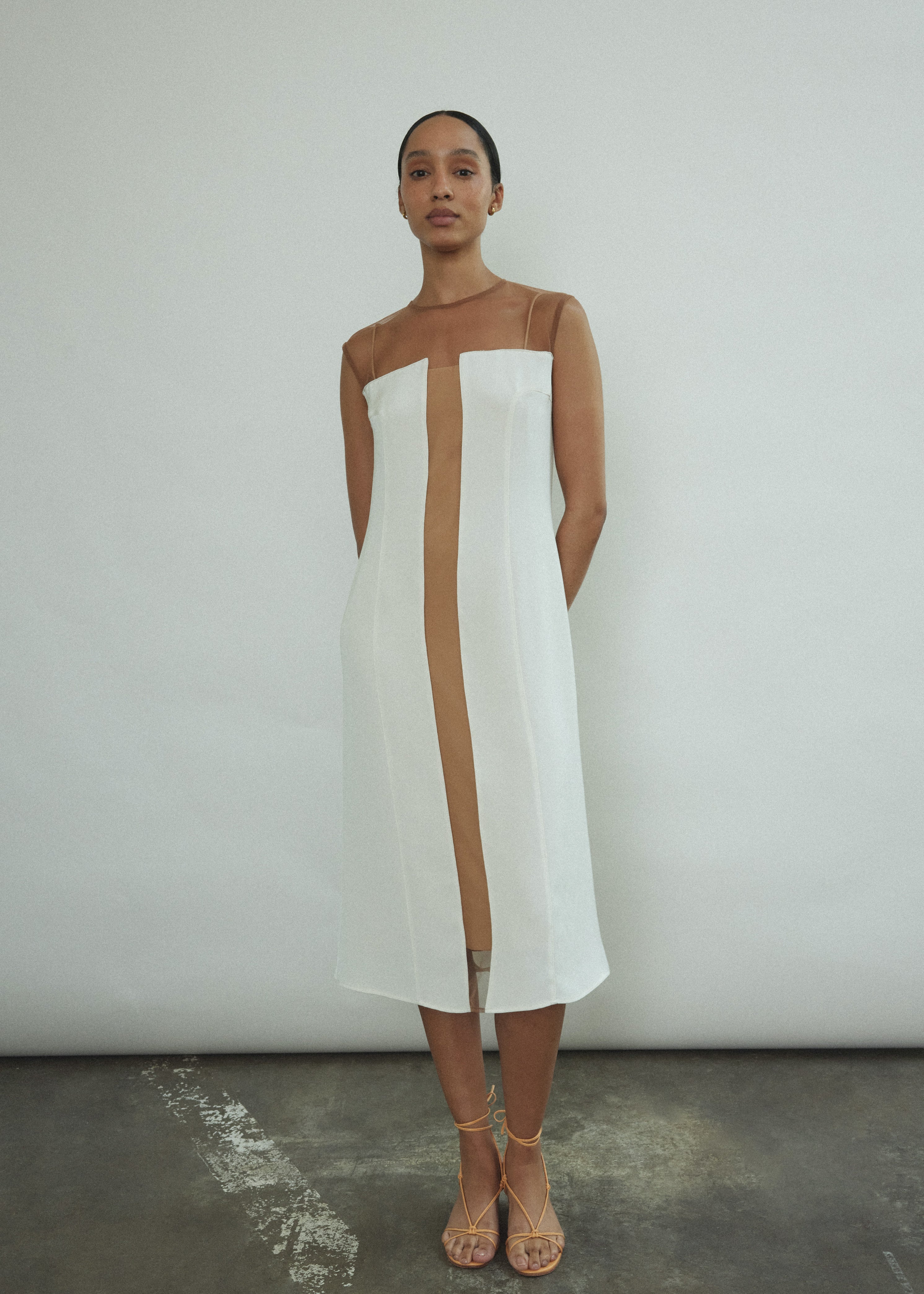 Front view of a bride wearing the ivory silk Kamperett Pirie Shift Dress, with sheer tulle illusion panel at neckline.