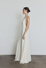 Editorial image of a bride wearing the alabaster Kamperett Ray Gown, a modern bridal halter gown.