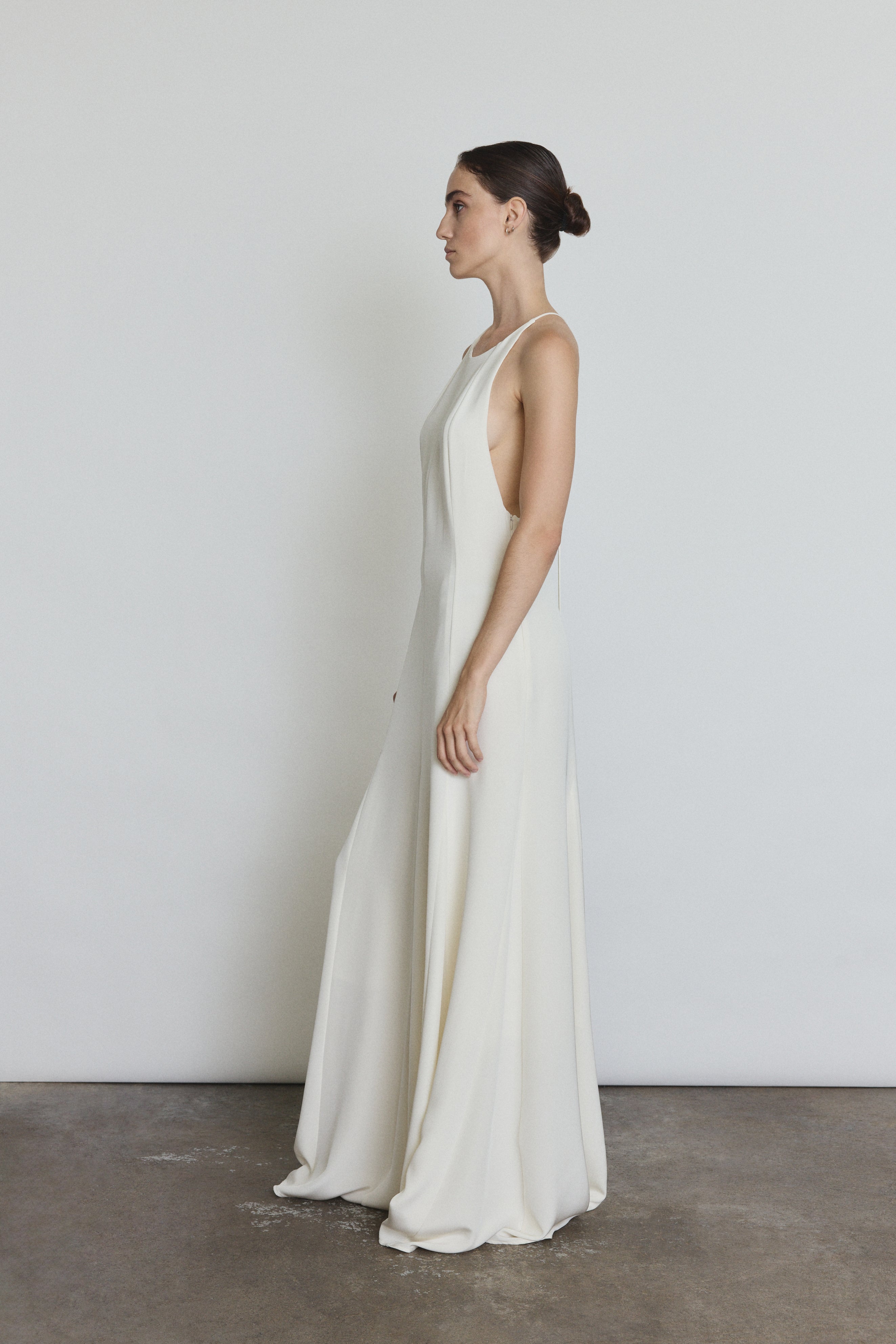 Editorial image of a bride wearing the alabaster Kamperett Ray Gown, a modern bridal halter gown.