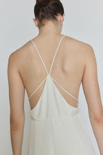 Editorial image of the alabaster Kamperett Ray Gown with the back straps tied around the waist.