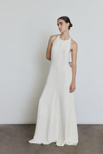 Front view of a bride wearing the alabaster silk crepe Kamperett Ray Gown, a bias-cut halter-neck wedding gown.