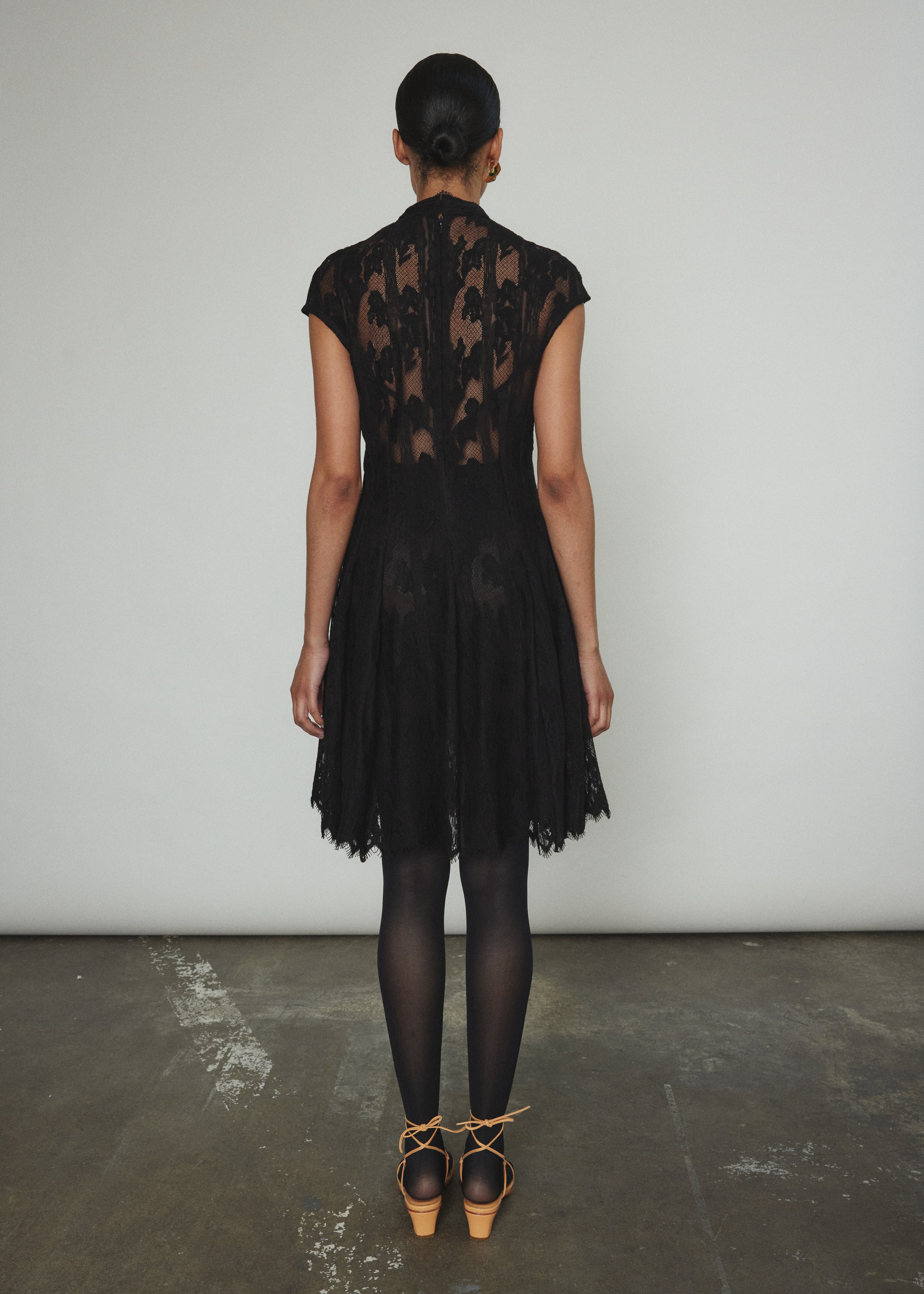 Detail of the eyelash lace edge and mock neck on the black French lace Kamperett Reine Dress.