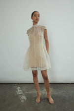 Angled view of the ivory silk organza Kamperett Reine Dress showing the sculpted French seams.