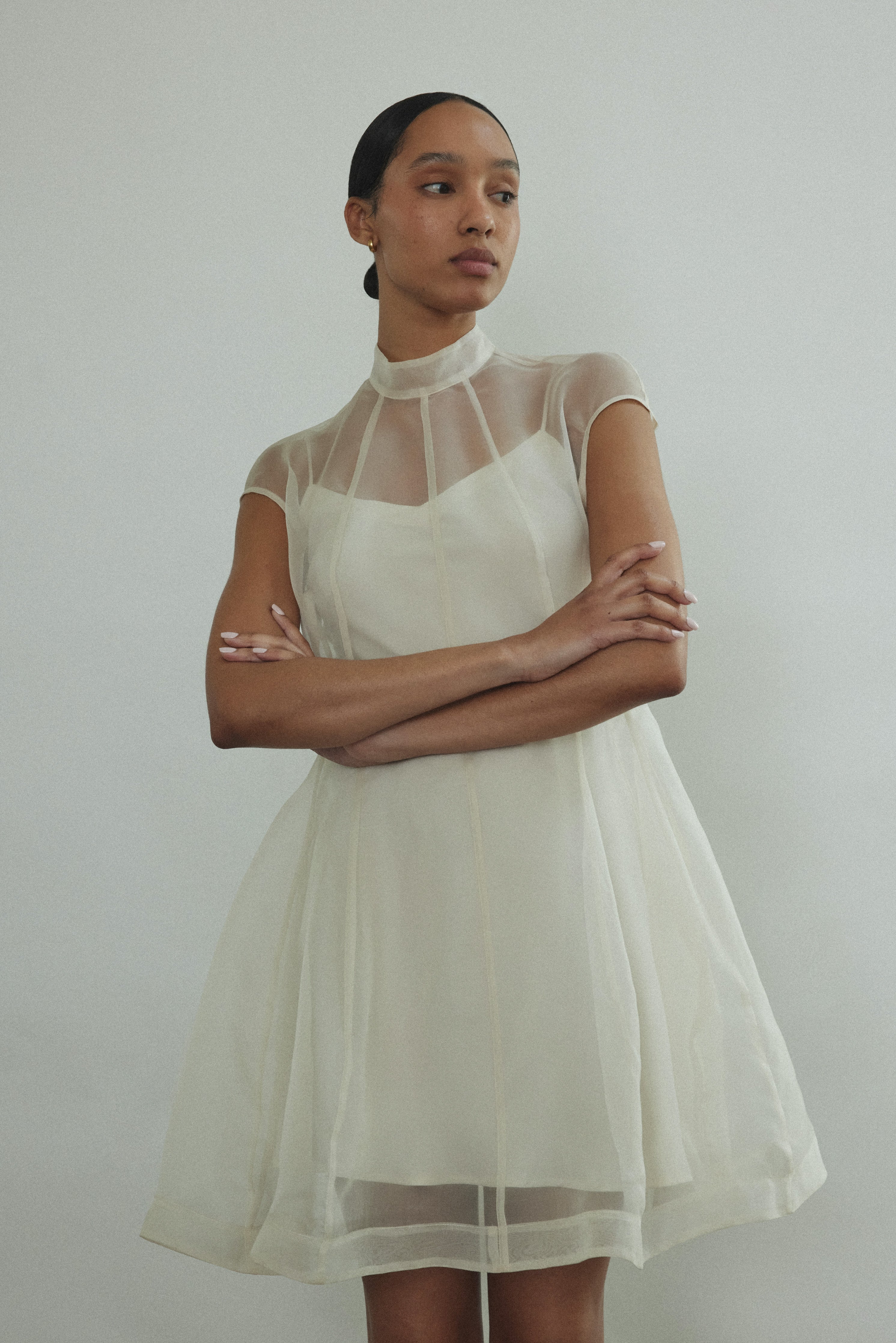 Editorial seated shot of the ivory silk organza Kamperett Reine Dress.