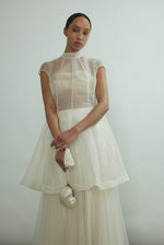 Editorial portrait of a bride in the ivory silk organza Kamperett Reine Dress.