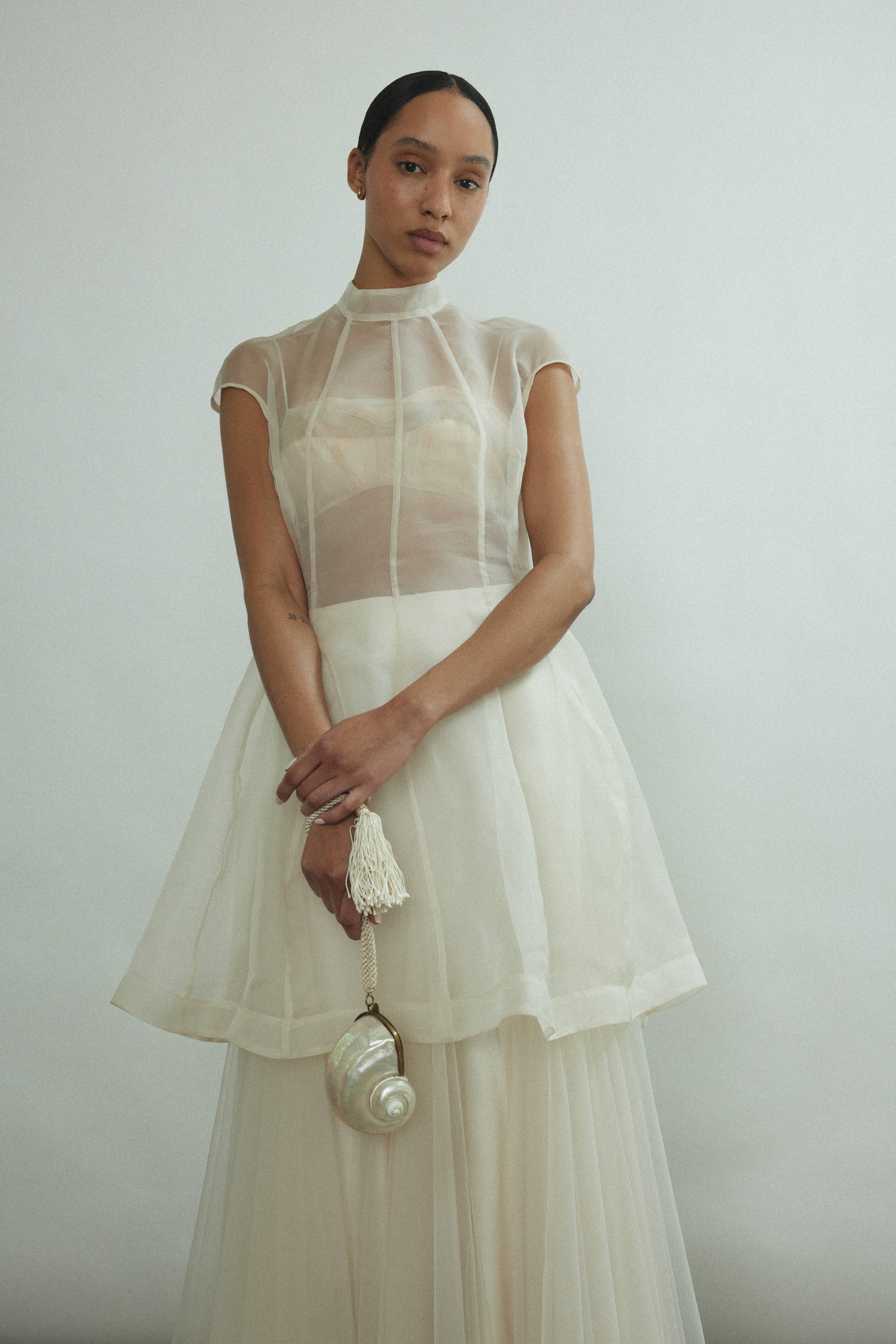 Editorial portrait of a bride in the ivory silk organza Kamperett Reine Dress.
