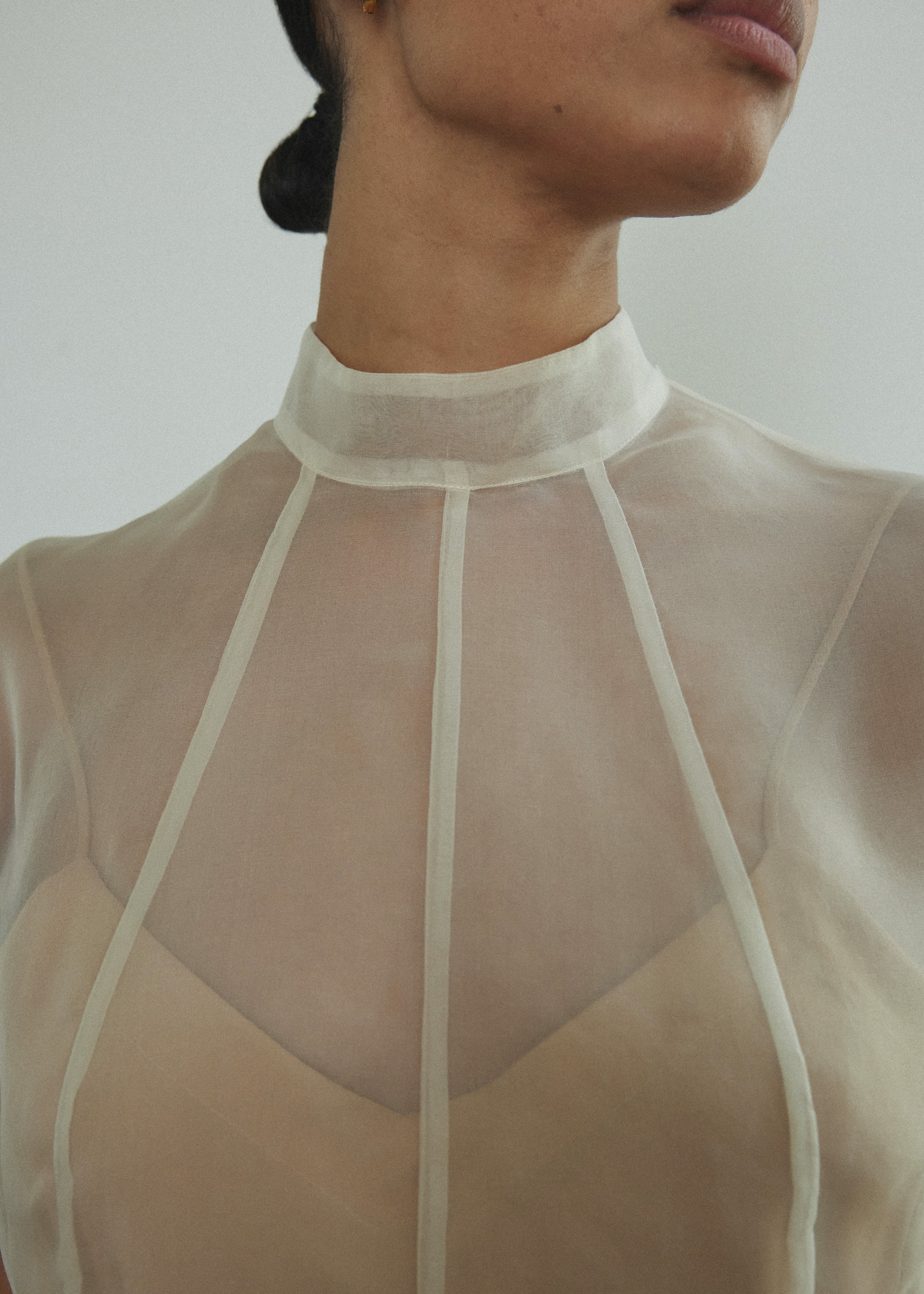 Side view of the ivory silk organza Kamperett Reine Dress with cap sleeves.