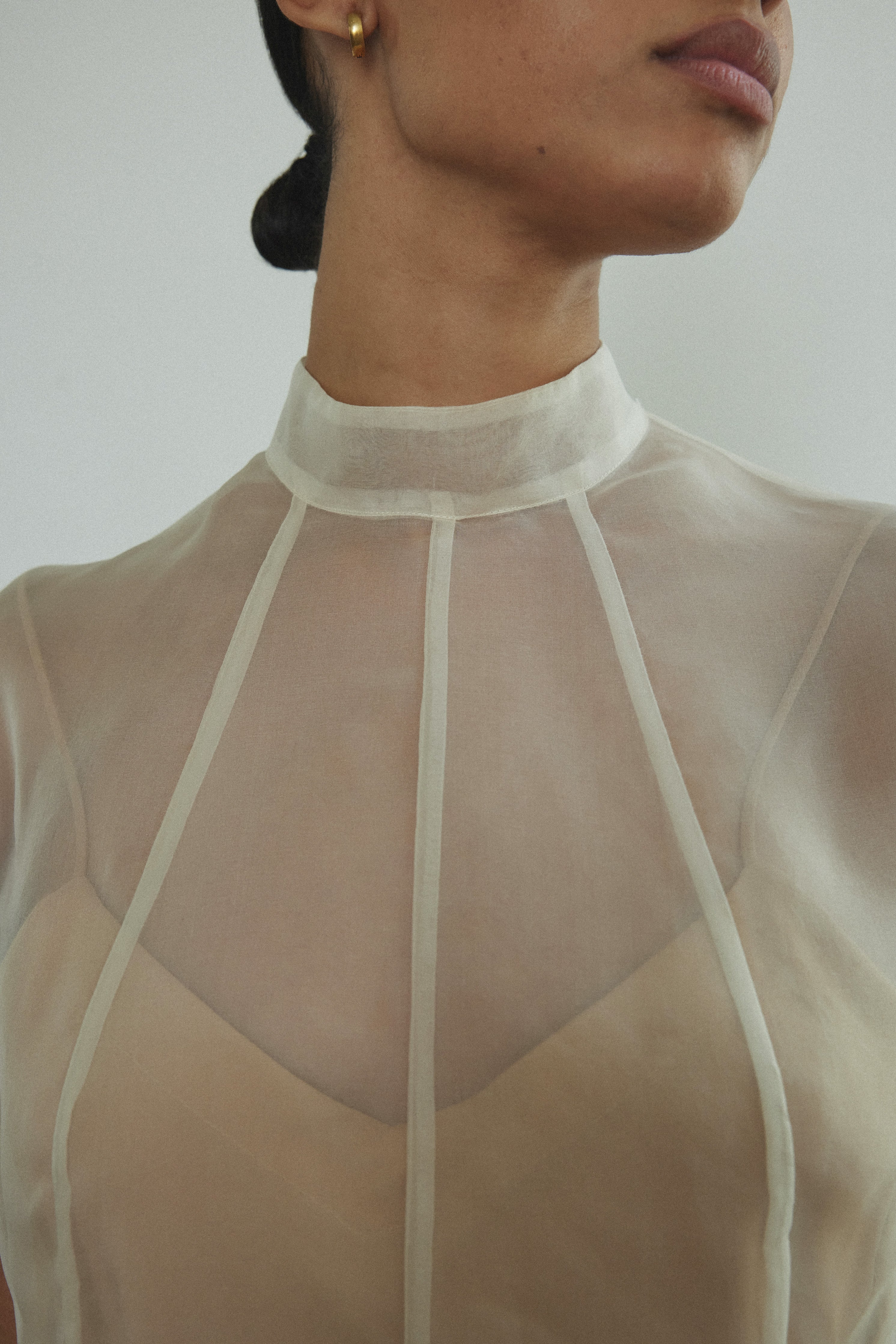 Side view of the ivory silk organza Kamperett Reine Dress with cap sleeves.