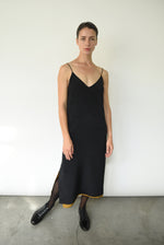 Editorial image of the brass silk charmeuse Kamperett Sade Slip Dress.